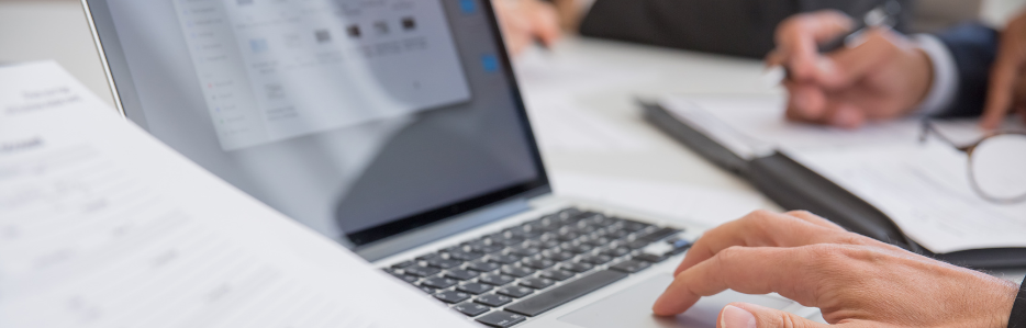 Reviewing documents on a computer and desk